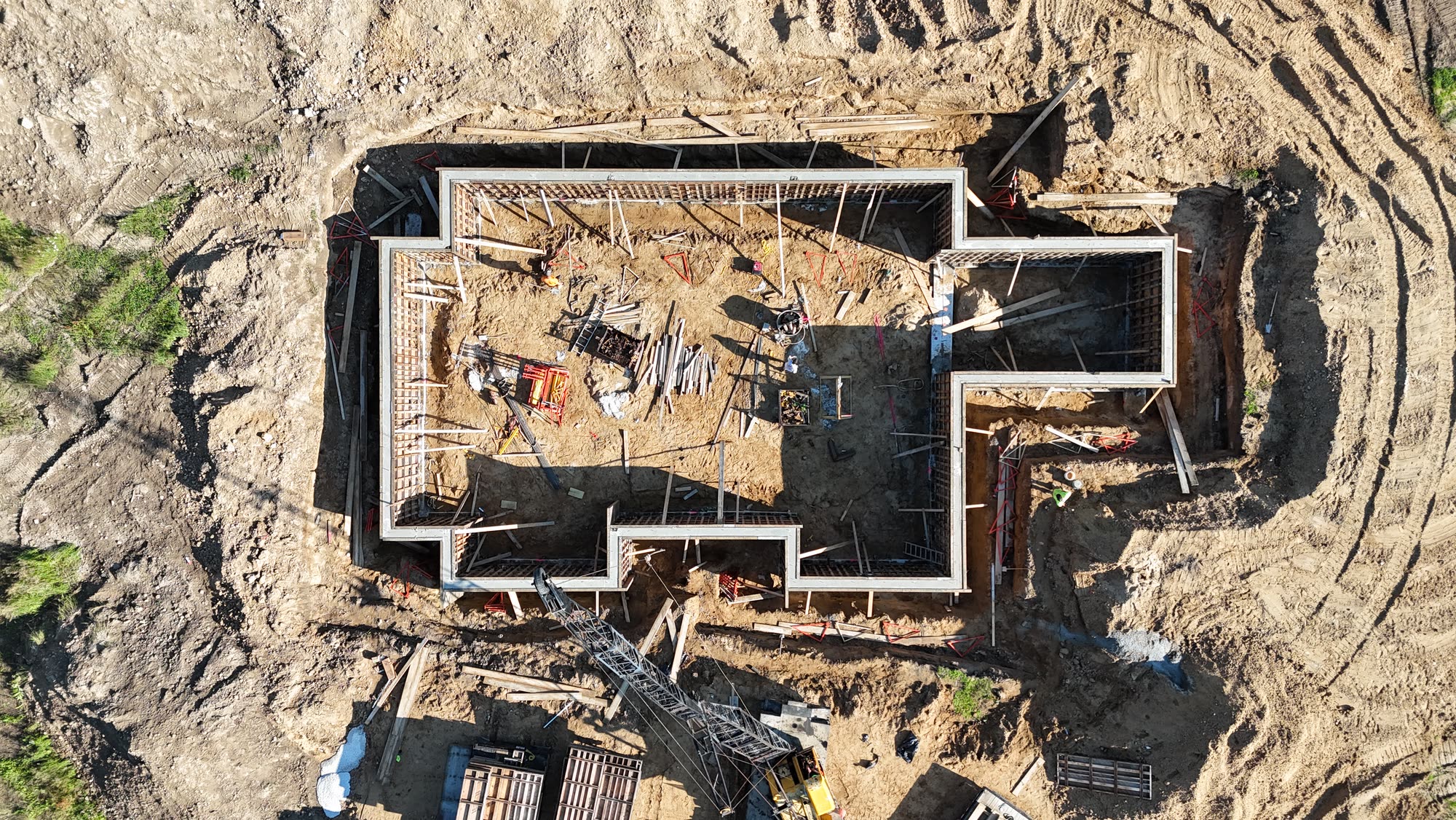 Top-down aerial view of the Fenton house foundation being poured